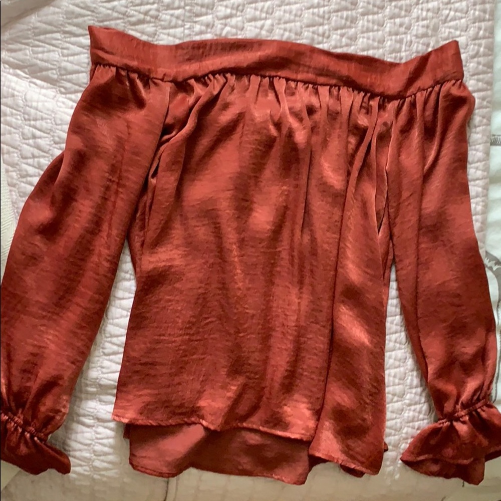 Off the shoulder burgundy/burnt orange blouse.